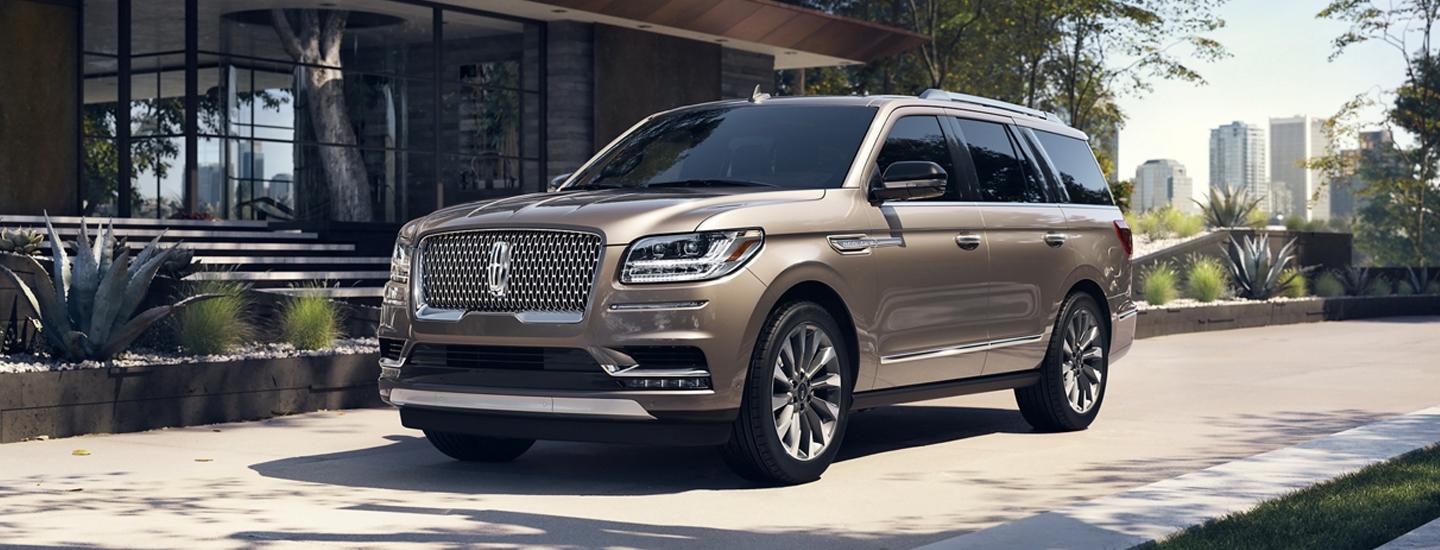 Front side view of a light brown 2020 Lincoln Navigator parked