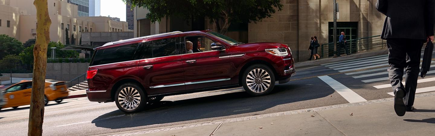 Red 2020 Lincoln Navigator driving uphill