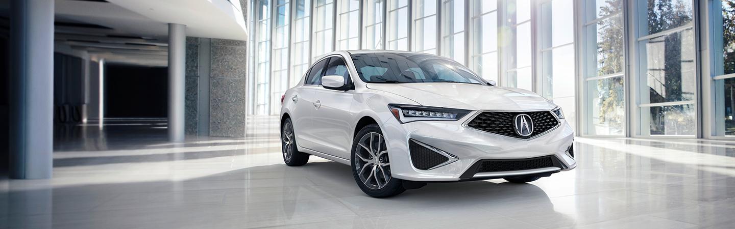 White Acura TLX Type S parked near a building.