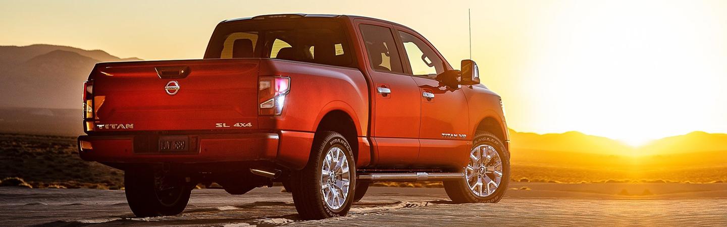 Red 2020 Nissan Titan parked with a sunset in the background