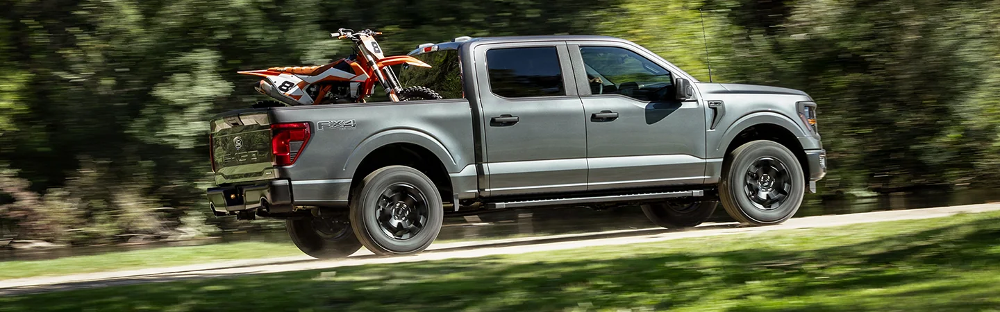 gray 2025 Ford F-150 driving in hills