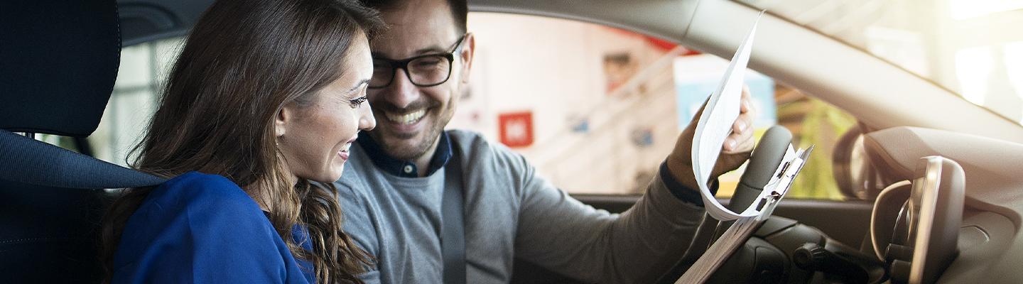 Woman and man in car smiling