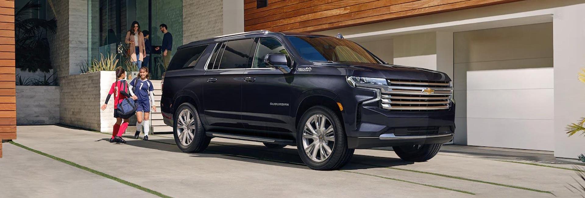 A 2022 Chevrolet Suburban parked in a homes driveway
