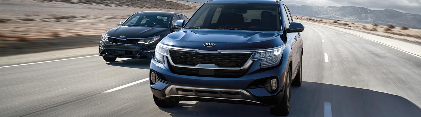 Two Kia vehicles driving next to each other