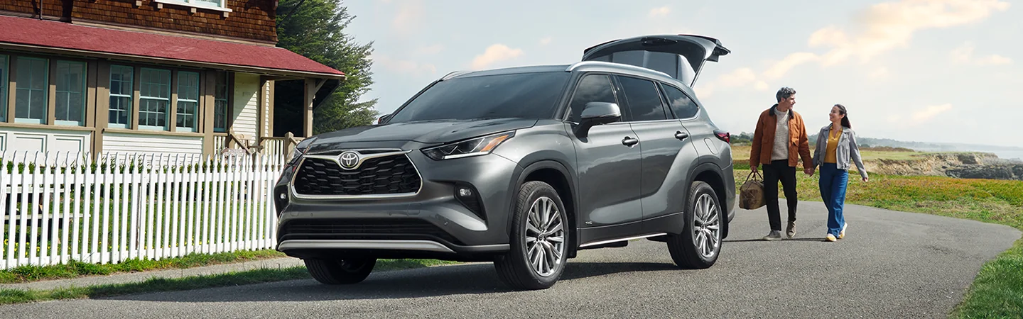 2025 Toyota Highlander Comparison Sliver Color Car and Man and Woman standard Front View