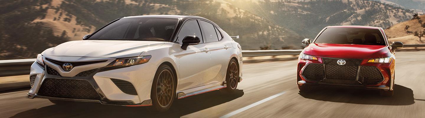 Two Toyota sedans in motion