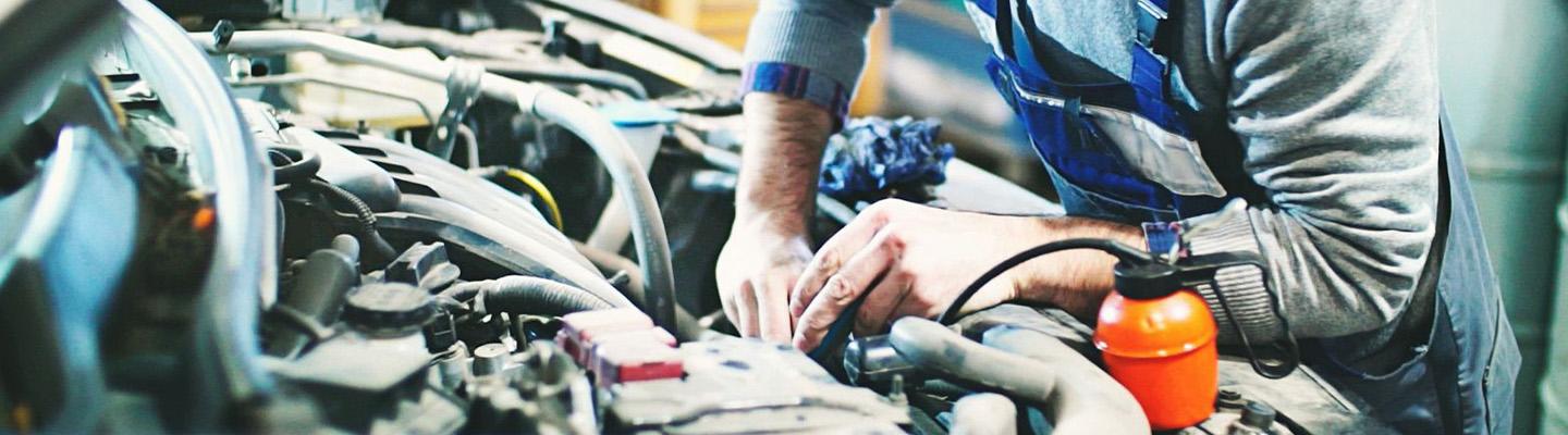 auto mechanic working in engine