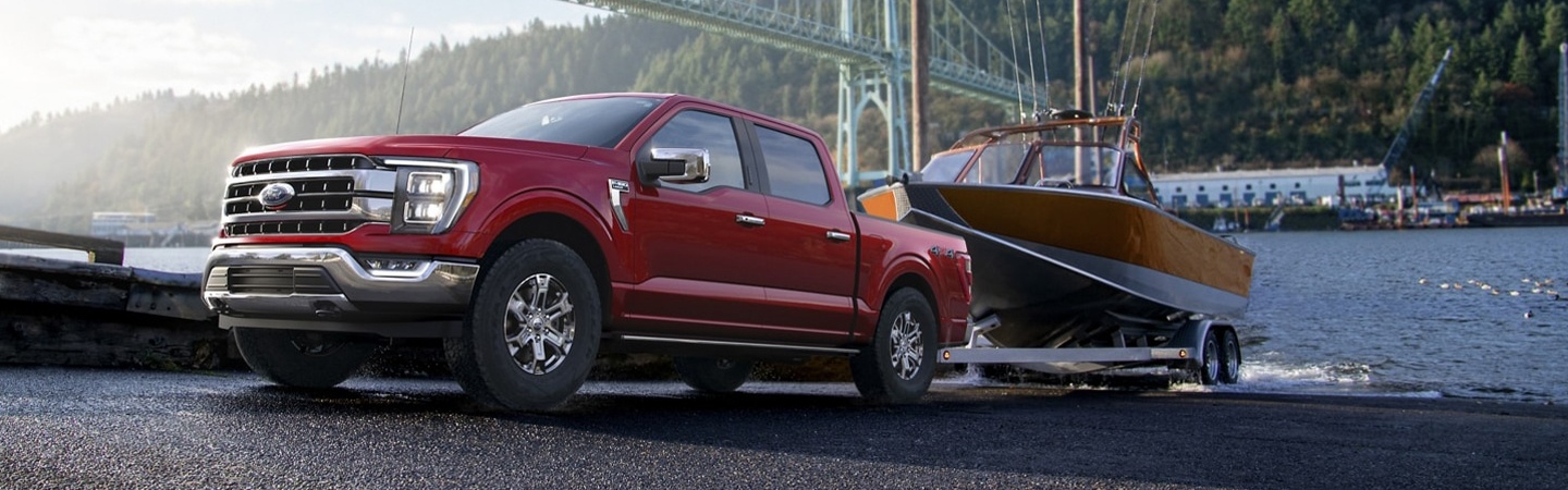 Red 2021 Ford F-150 towing a boat