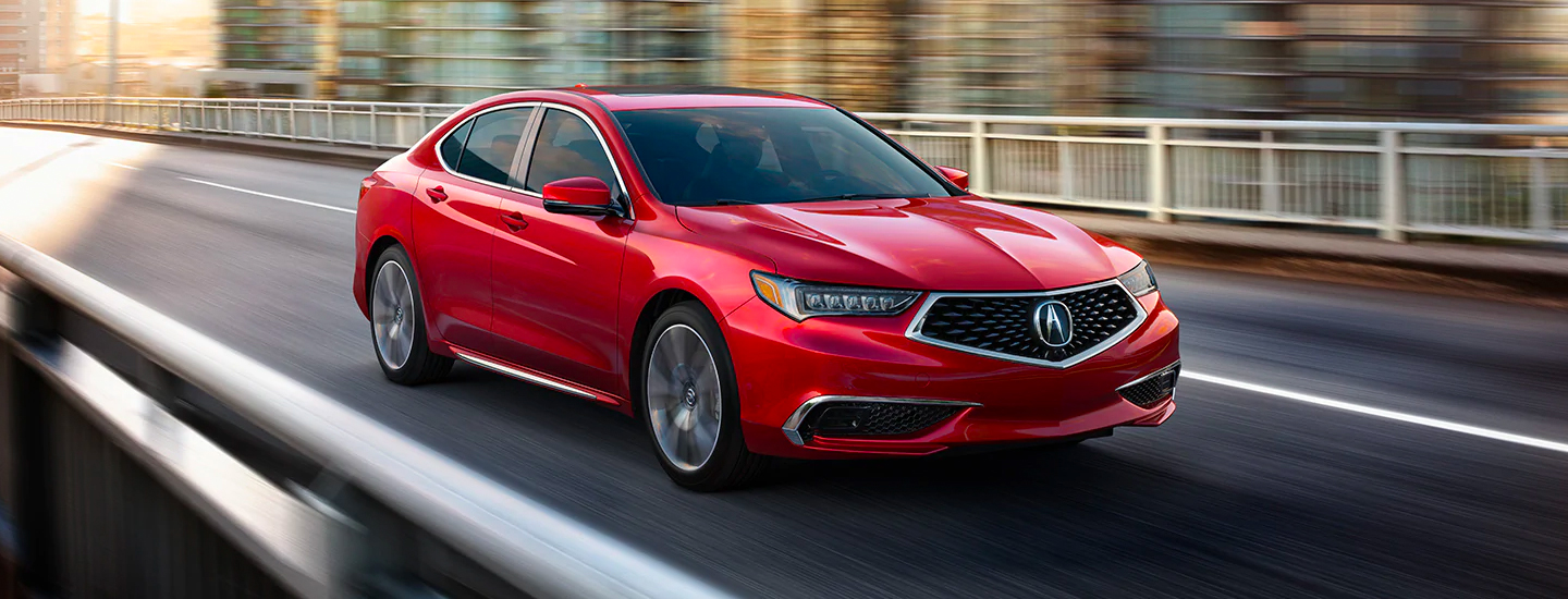 Red Acura TLX in motion