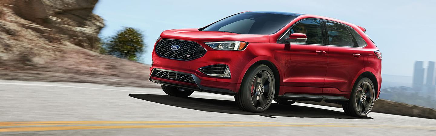 Red 2020 Ford Edge driving on the road