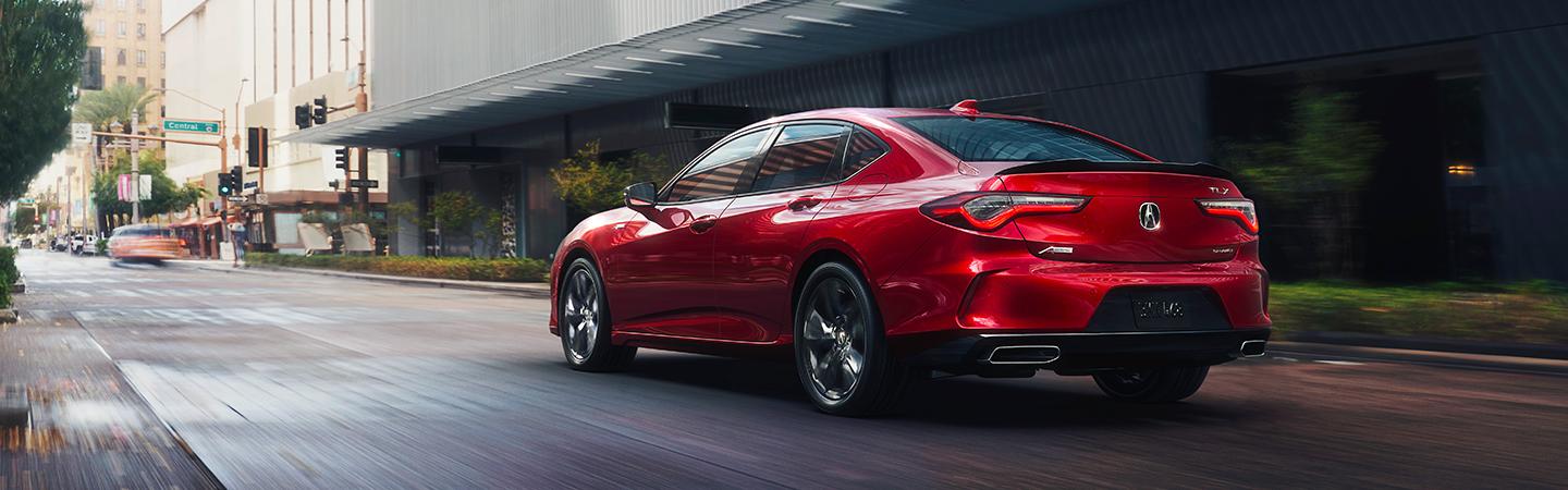 red acura facing away from camera