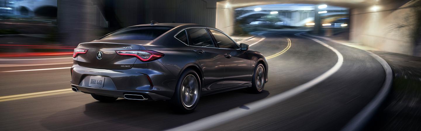 silver gray acura on winding road