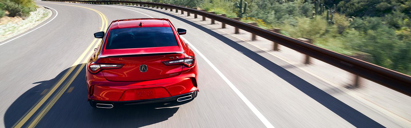 red acura driving