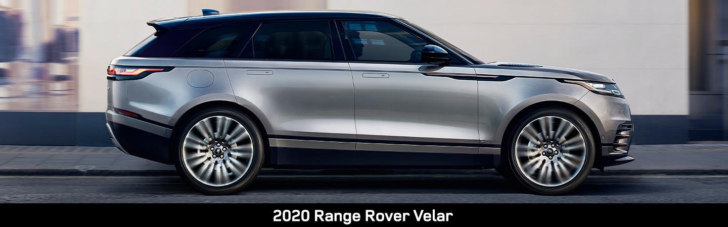  Side view of a silver 2020 Range Rover Velar driving in the city