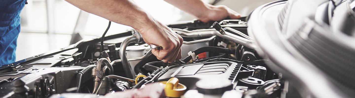 Service tech working on an engine