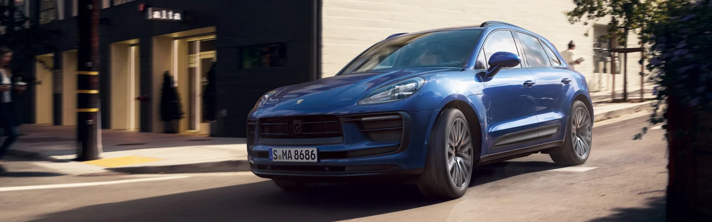 blue Porsche Macan on street