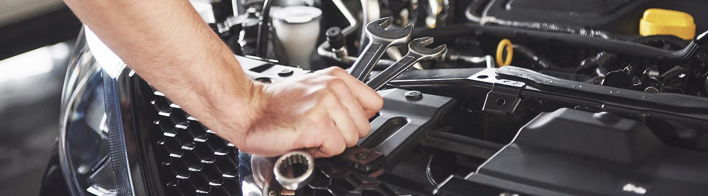 Close up view of a technician working on an engine