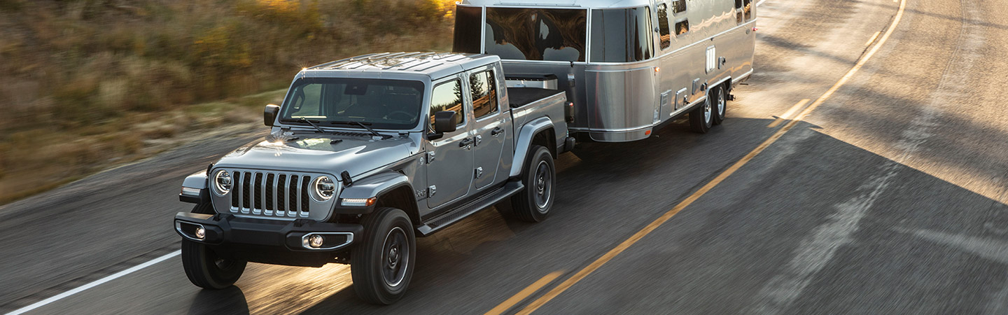 Silver 2020 Jeep Gladiator towing a trailer
