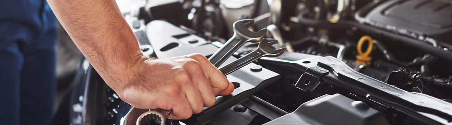 Auto mechanic working on engine