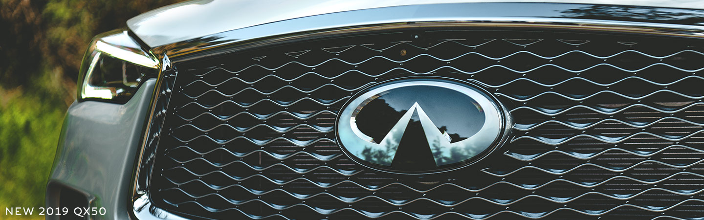 Close up of the INFINITI logo on the QX50