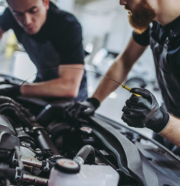 mechanics changing oil