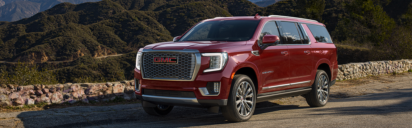 Red 2021 GMC Yukon parked on the side of the road