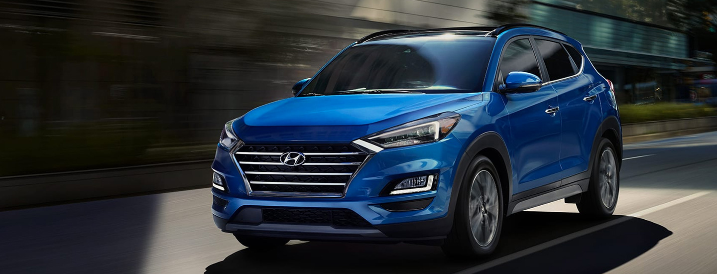 Blue Hyundai Tucson in motion