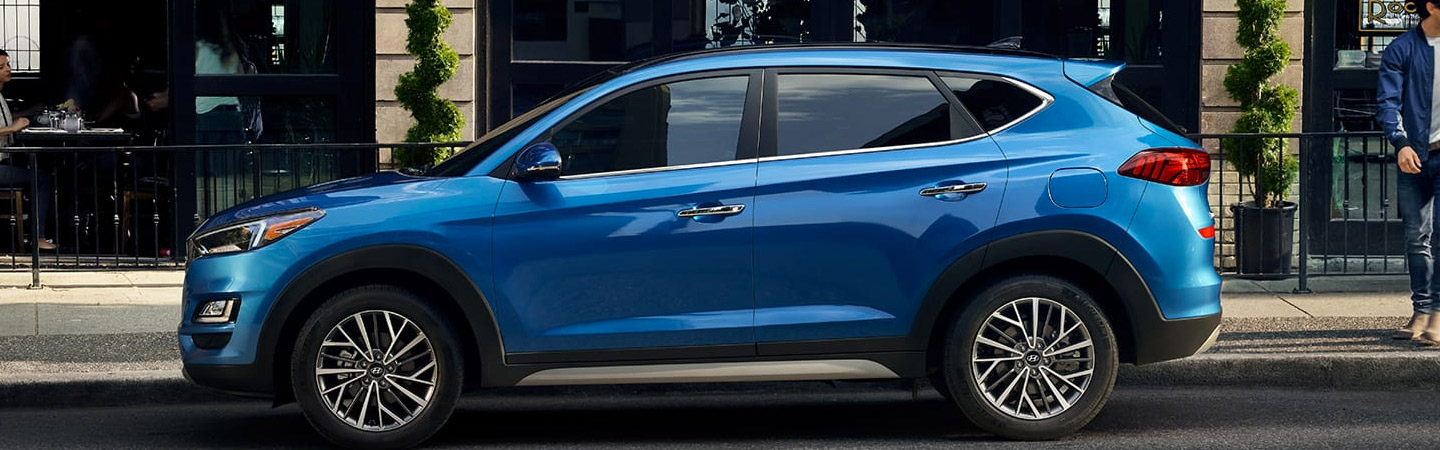 Drivers side view of blue Hyundai Tucson