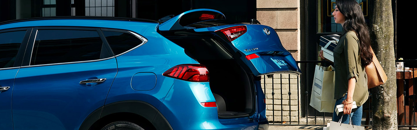 Blue Hyundai Tucson with hatch opening