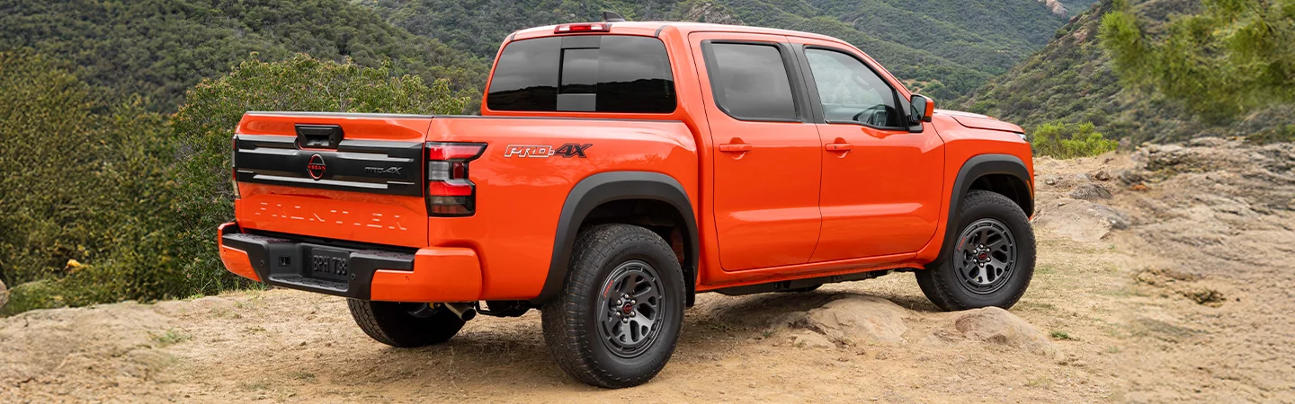 Rear view of the 2025 Nissan Frontier SL parked on a mountain