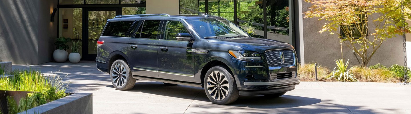 Blue Lincoln pulling out of home driveway