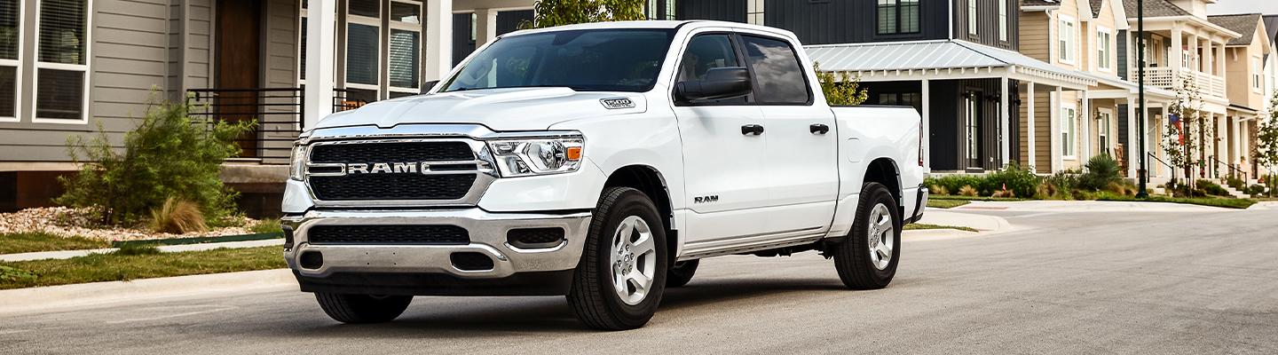 White 2020 Ram 1500 parked in a neighborhood.