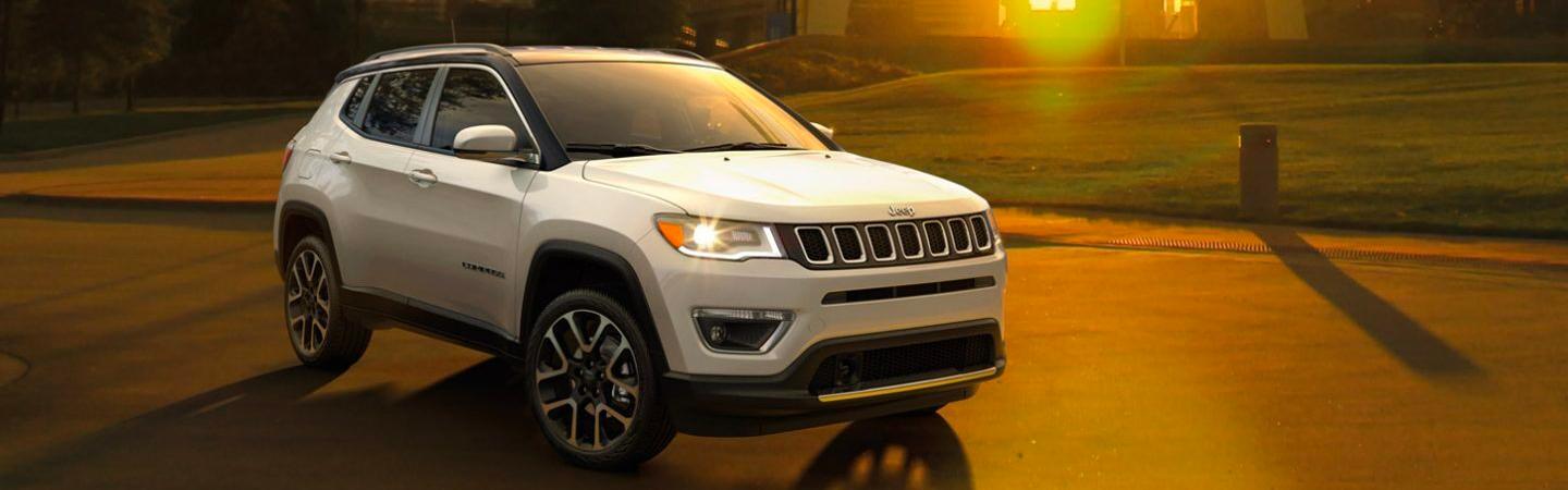 White 2021 Jeep Compass turning on a road