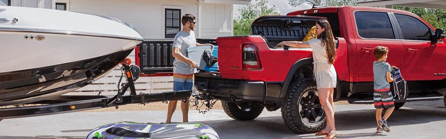 Family loading cargo and towing boat with the 2020 RAM 1500
