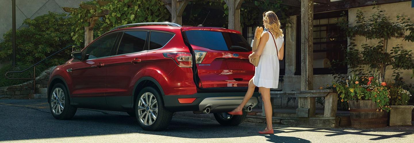 Rear view of a used Ford Escape utilizing its hands free trunk