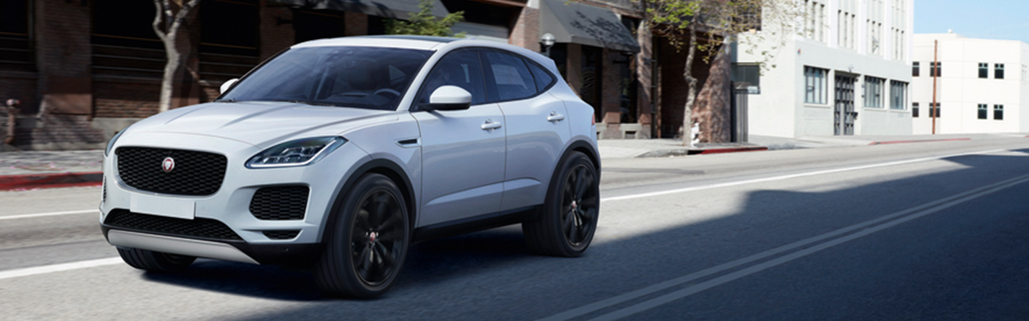 White Jaguar E-PACE in motion in city