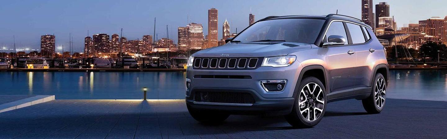 2021 Jeep Compass parked next to water at night