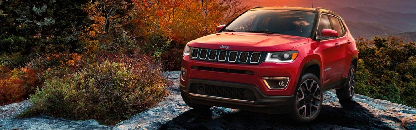 Red 2021 Jeep Compass parked on a rock