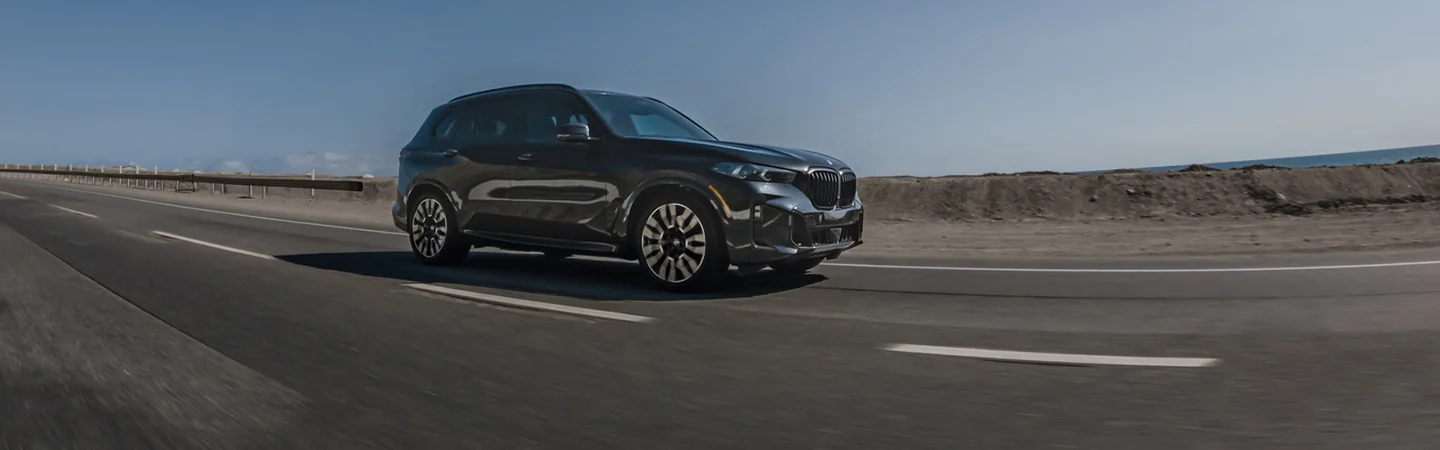 passenger side view of a 2026 BMW X5 M Competition in motion