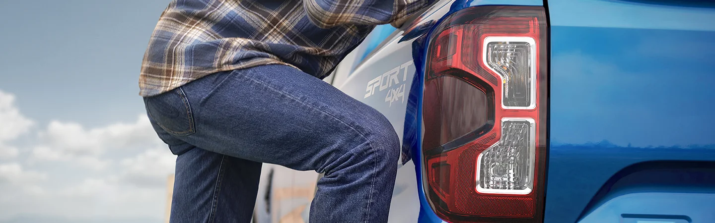 rear view with a person leaning on the 2025 Ford Ranger Raptor