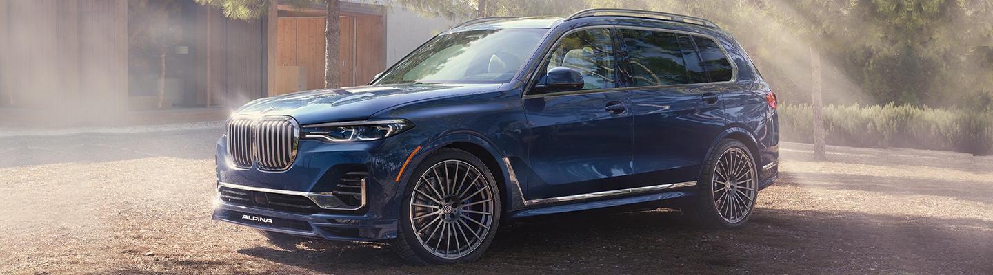 Blue BMW X7 Parked On Dirt