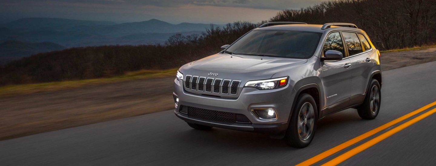Silver Jeep Cherokee riding in motion
