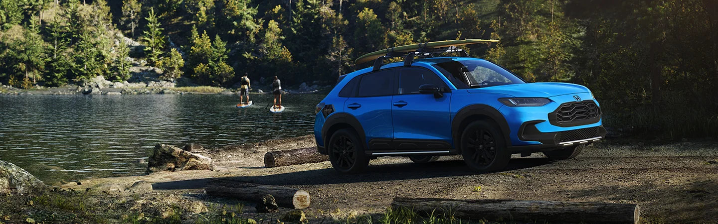 2026 Honda HR-V parked in front of a lake with paddleboarders in the background