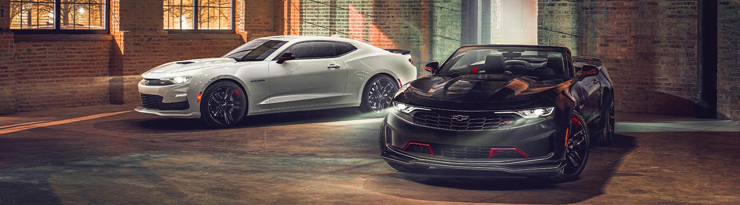 Two Chevy Camaro’s parked side by side.