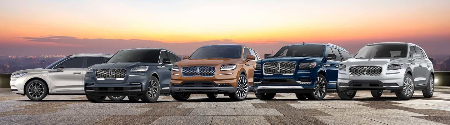 Five Lincolns lined up side by side on top of a parking garage