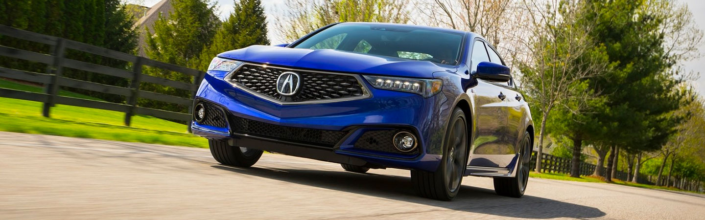 Blue Acura TLX in motion