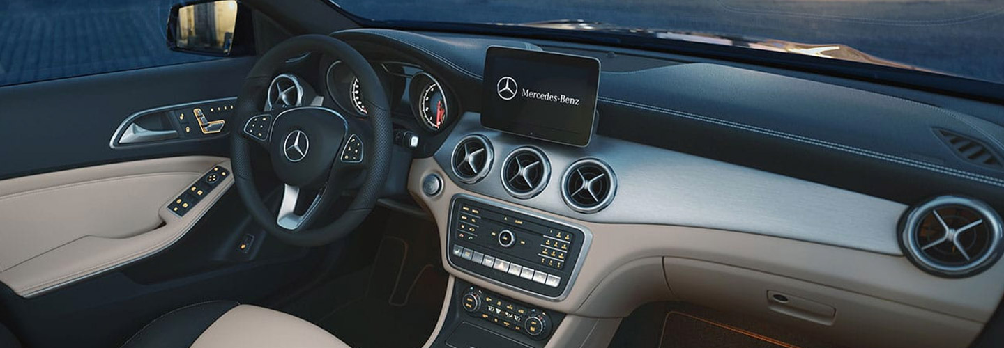 The Steering wheel and infotainment system of a Mercedes SUV