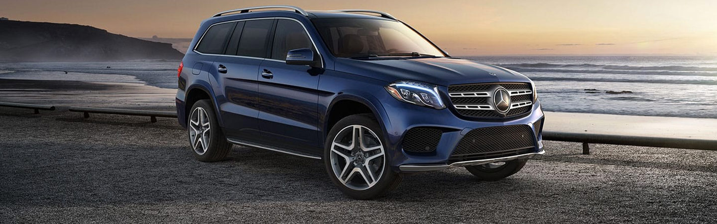 Blue Mercedes-Benz SUV by the ocean