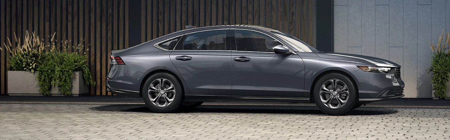 Side view of the 2025 Honda Accord parked next to a building