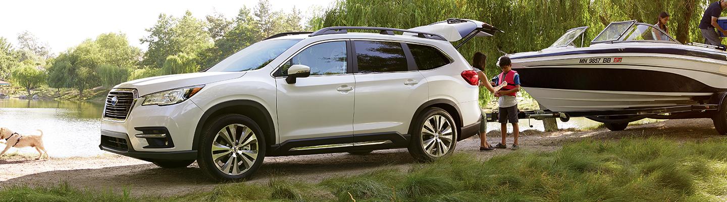 White 2021 Subaru Ascent Towing Boat Next to Lake